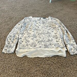 Floral dress top with a cream underlayer. Cuffed sleeves with button detail.